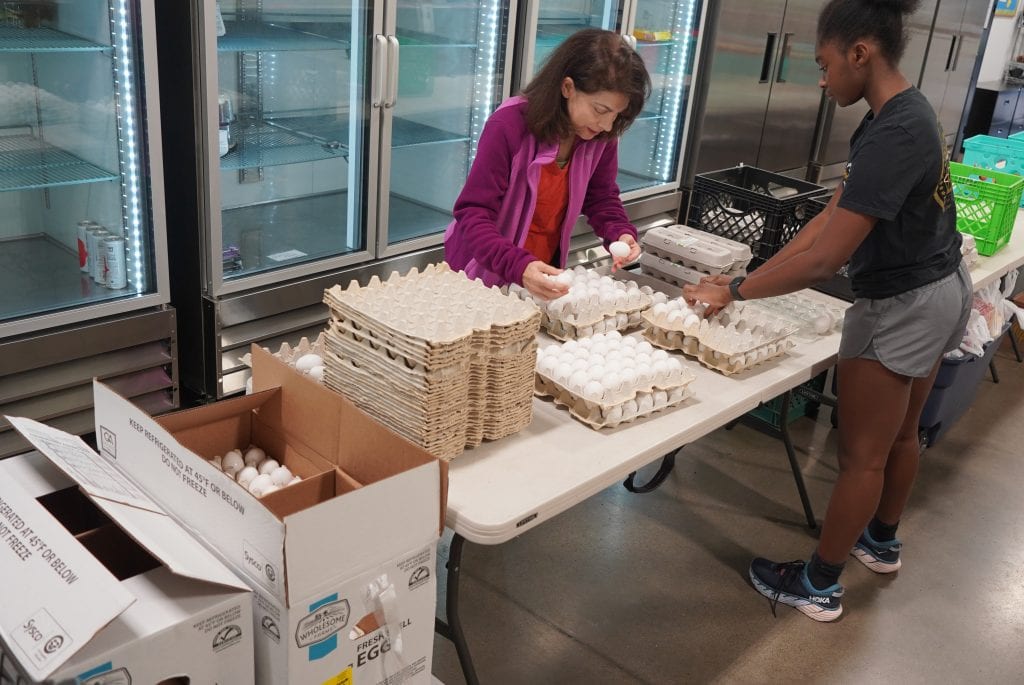 bulk egg buying, egg sponsorhip, volunteers, volunteers repacking eggs